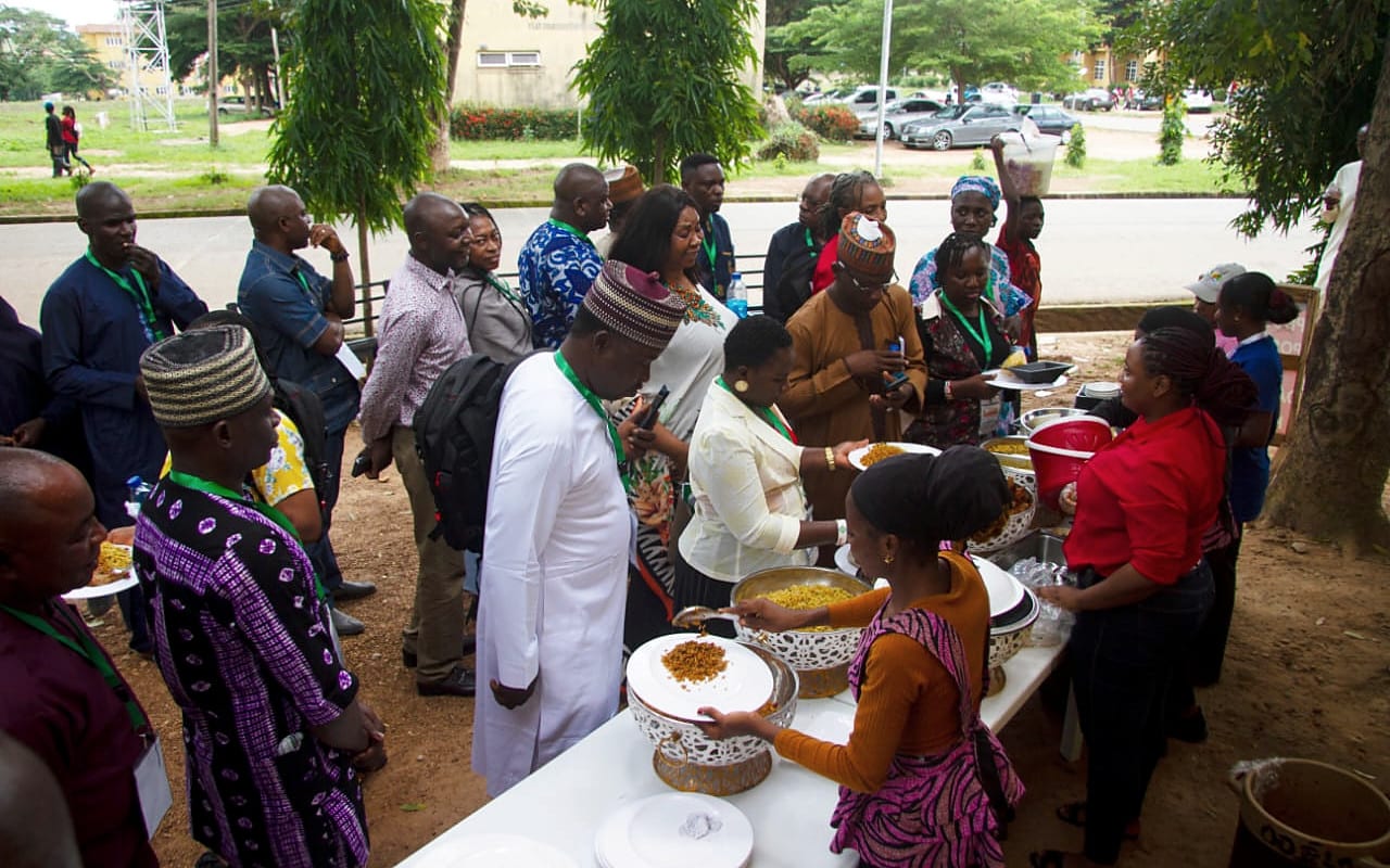 Participants gathering outdoors between programme sessions.