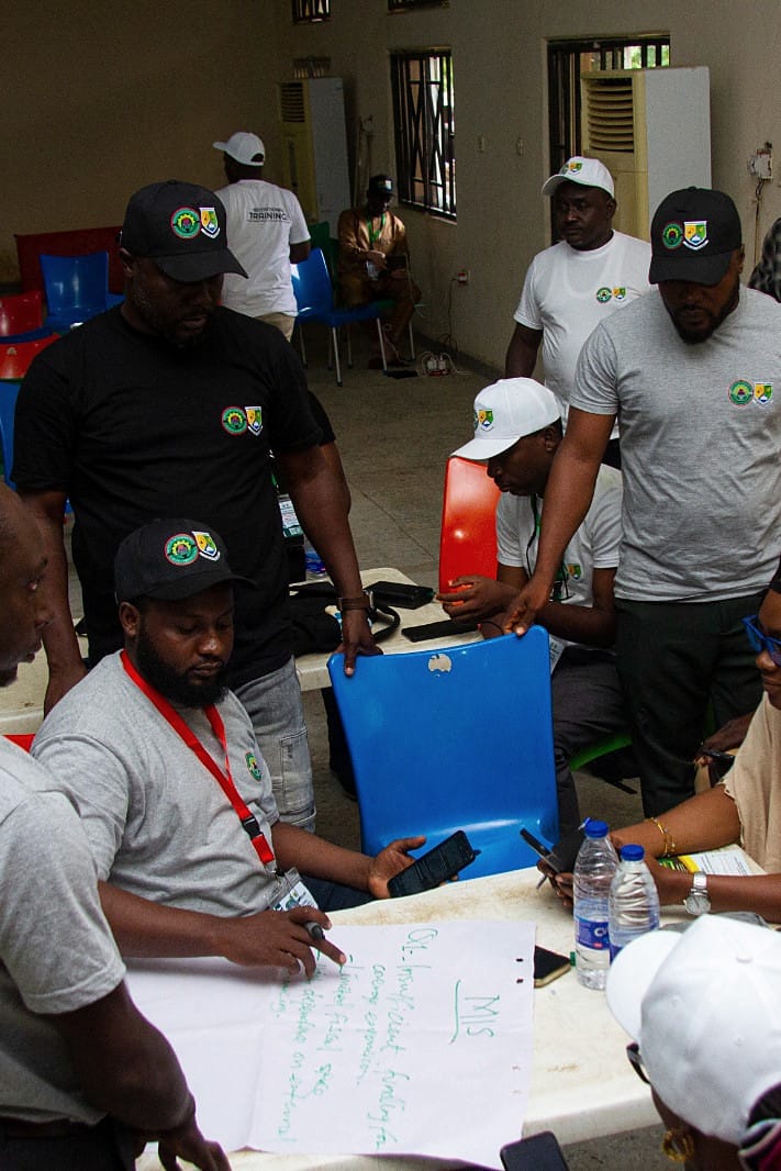 Participants gathered around a flipchart during a training workshop.