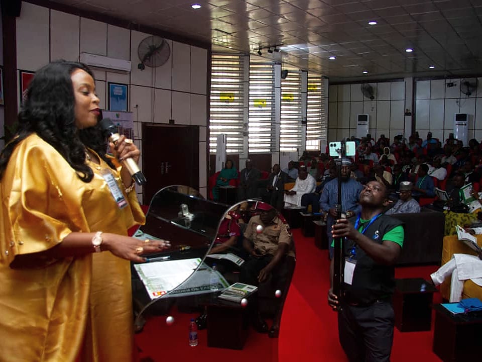 Dr. Comfort Adokwe Obed, Founder and Executive Director, addressing a full hall of delegates.