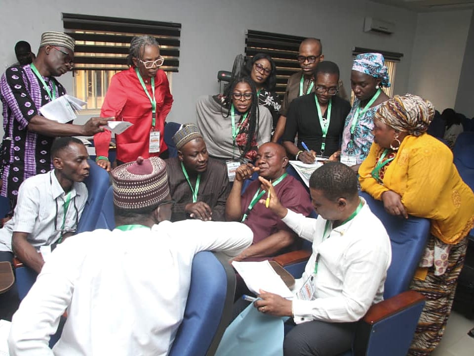 Researchers and participants reviewing documents together during a working session.