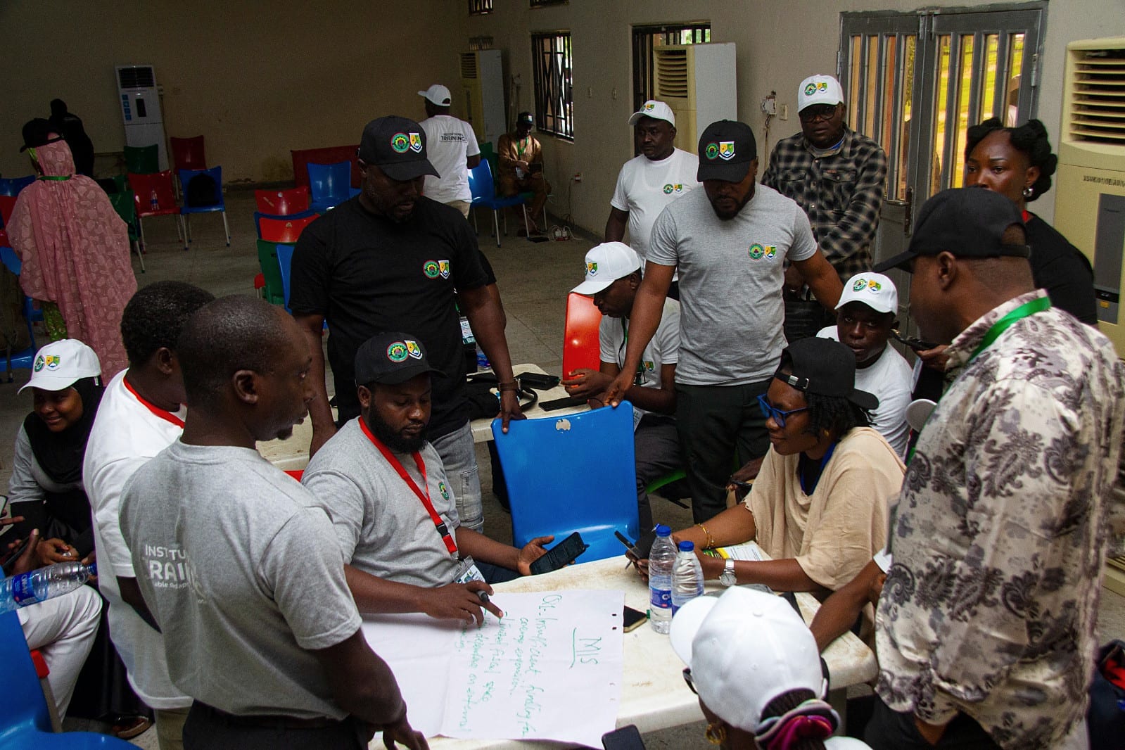 Participants gathered around a flipchart during a training workshop.